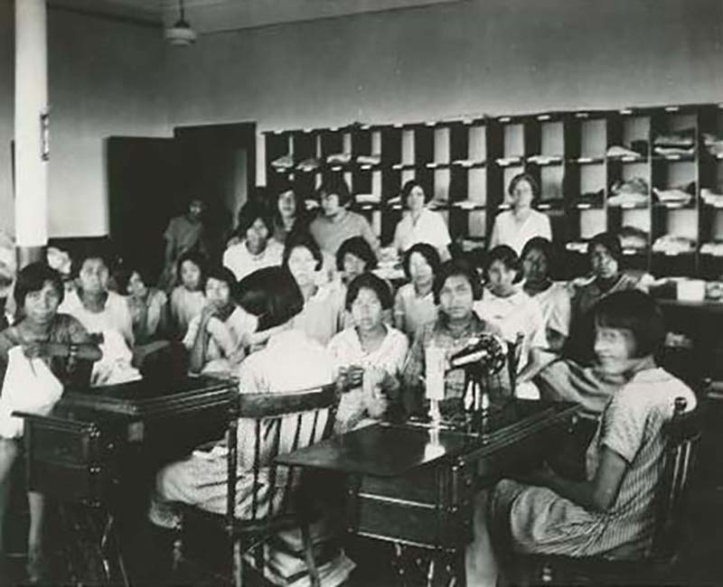 group of people at sewing machines at Edmonton Poundmaker school