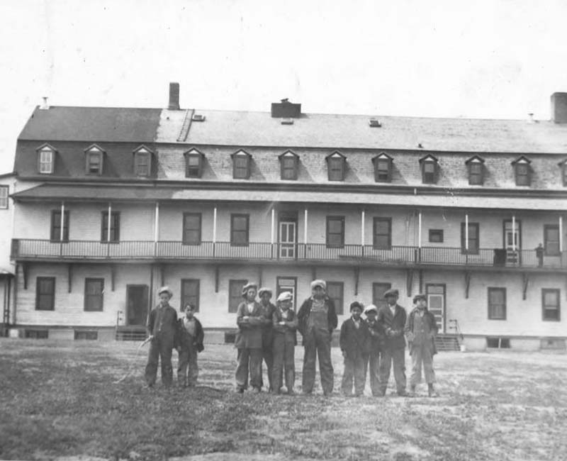 Group of students outside building at Ermineskin Hobbema school