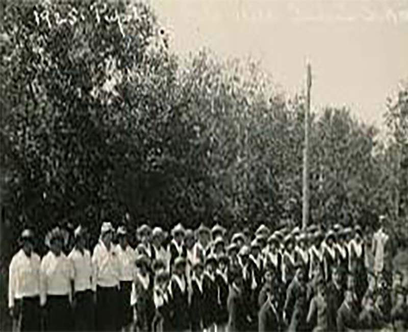 Group of people in front of File Hills school