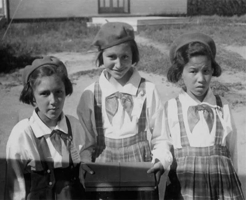 Three students outside at Holy Angels Fort Chipewyan School 