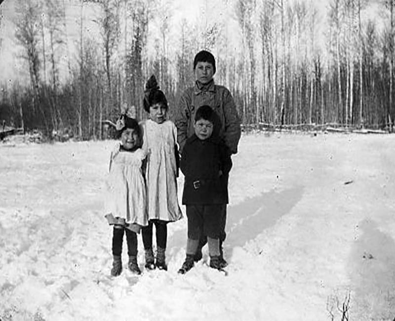 Group of four students outside at Lesser Slave Lake school 