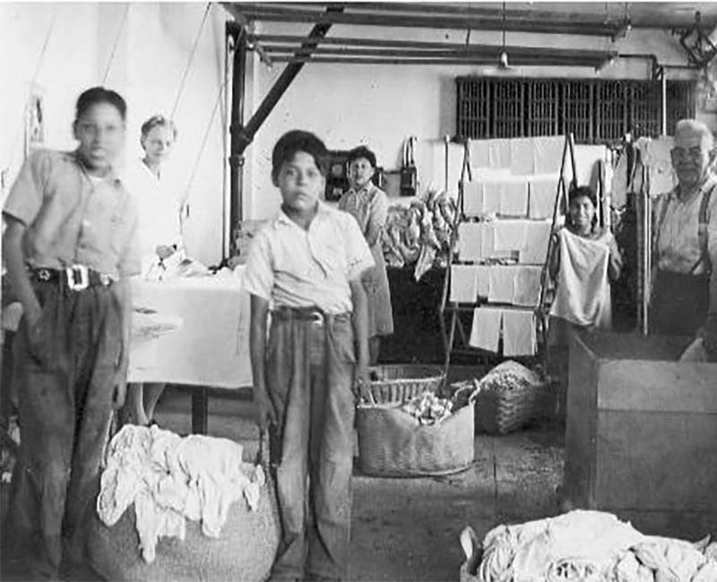 Group of people doing laundry at Old Sun Blackfoot school