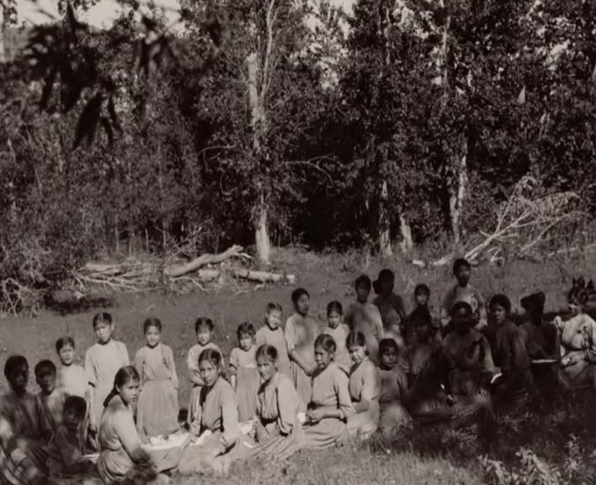 group of students sitting outside Lejac Stuart Lake school 