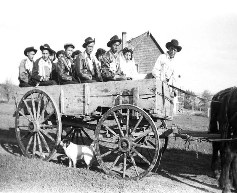 group of people in wagon outside at Wabasca St. Johns school