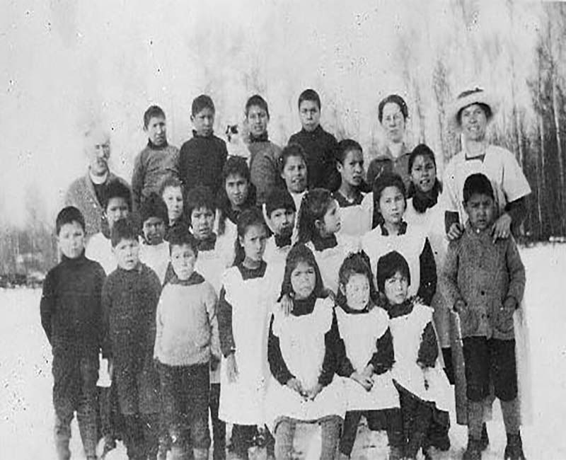 Group of students and teachers outside of building at Whitefish Lake St. Andrews school