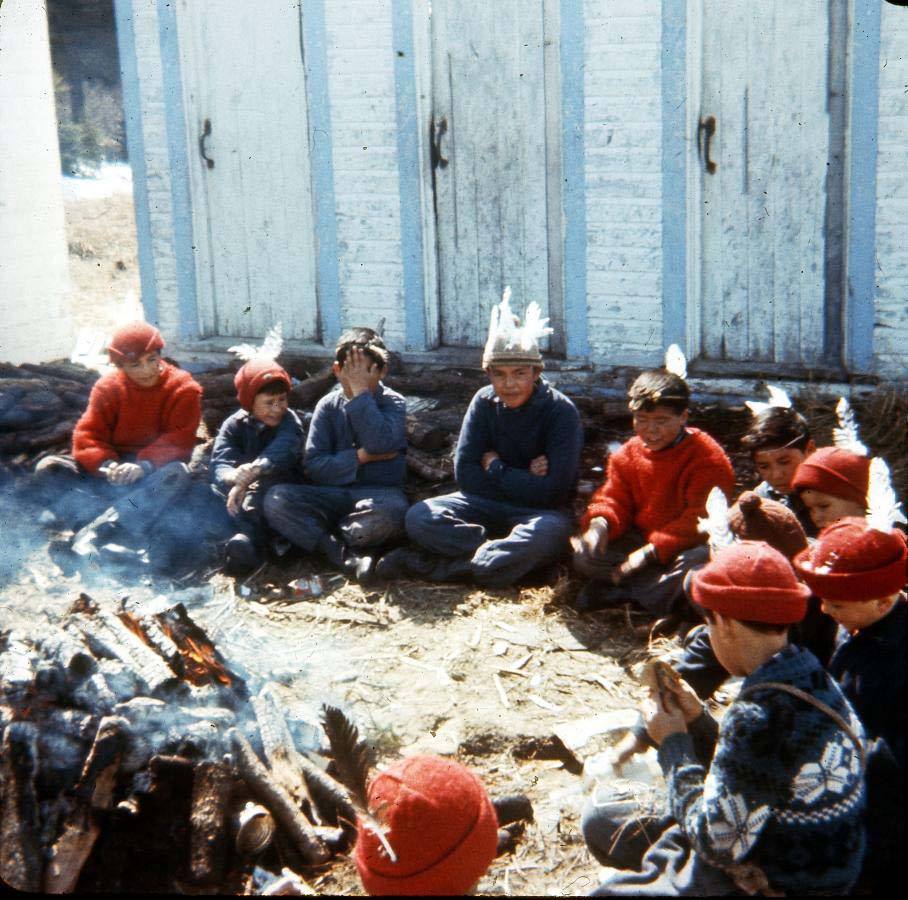 Group of children sitting around a fire