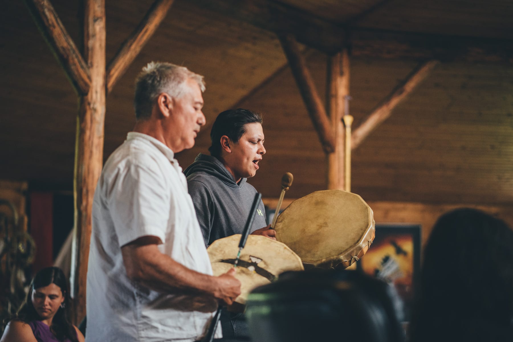 Two people drumming in Turtle Lodge