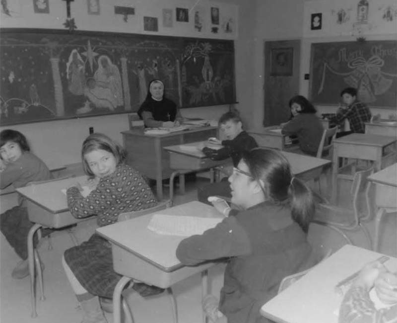 Students in desks at Fort George Roman Catholic school