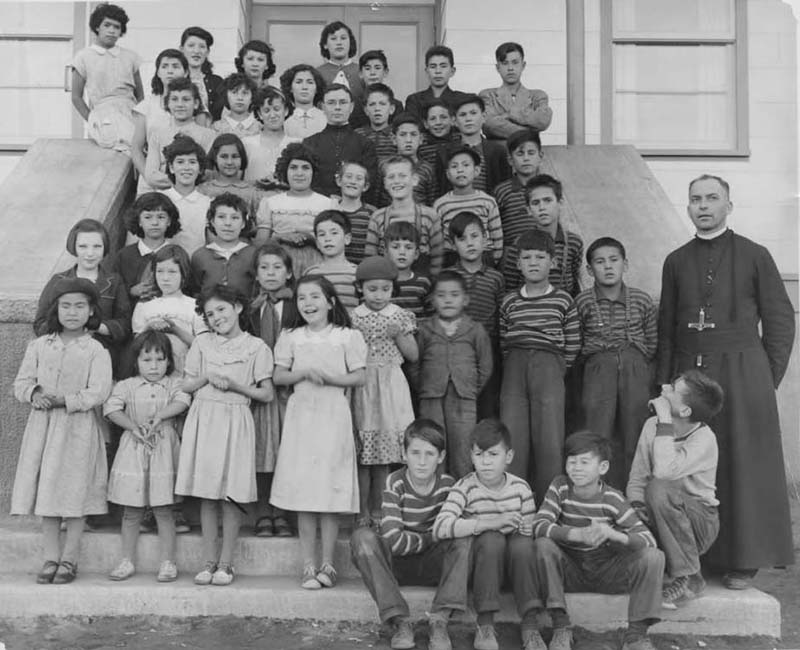 Students and teacher posing for photo in front of Sept-Iles school