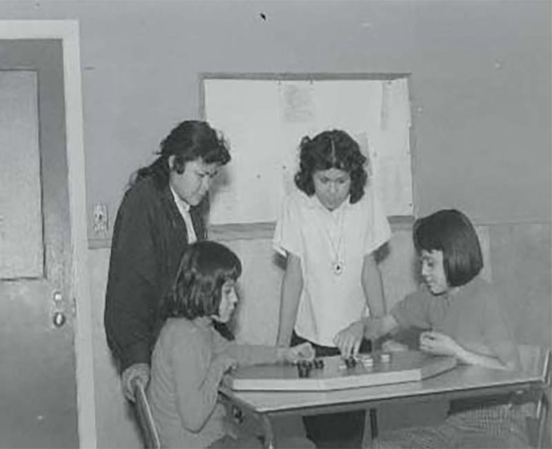 Group of four students playing a game in Yukon Hall Whitehorse school