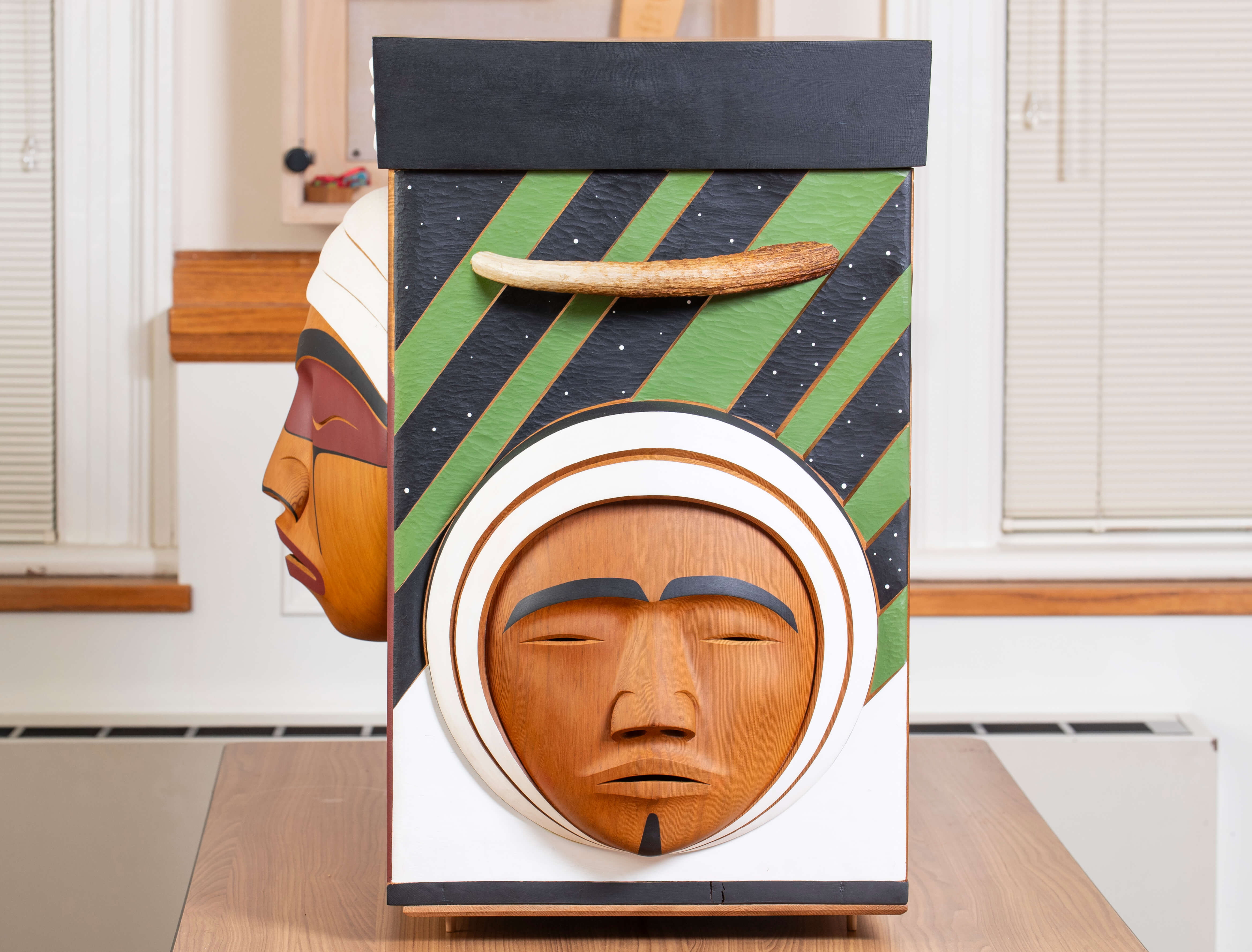 The side of the Bentwood Box, displaying imagery representing former Inuit residential school students.