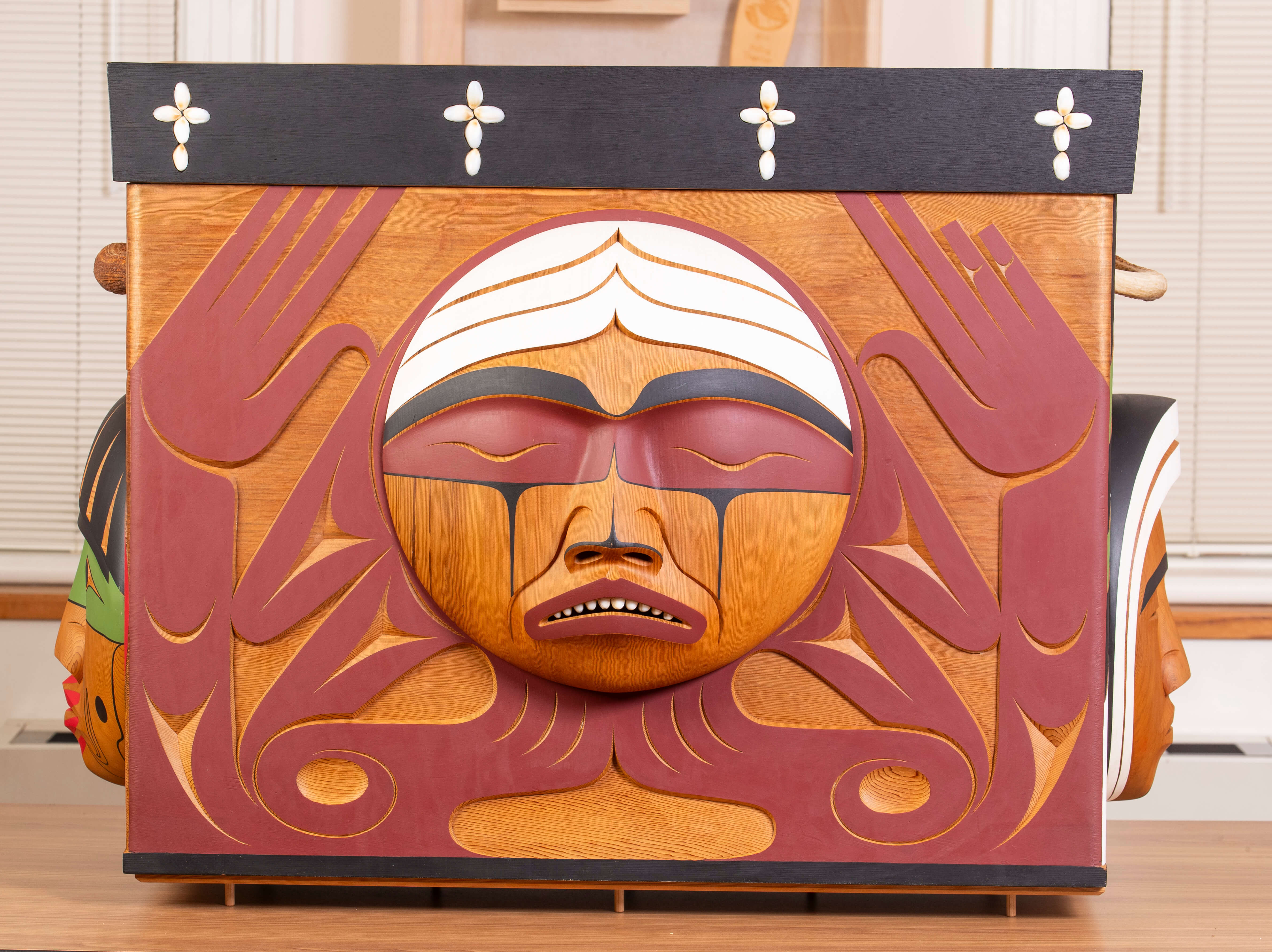 The front of the Bentwood Box, displaying imagery representing former First Nations residential school students.