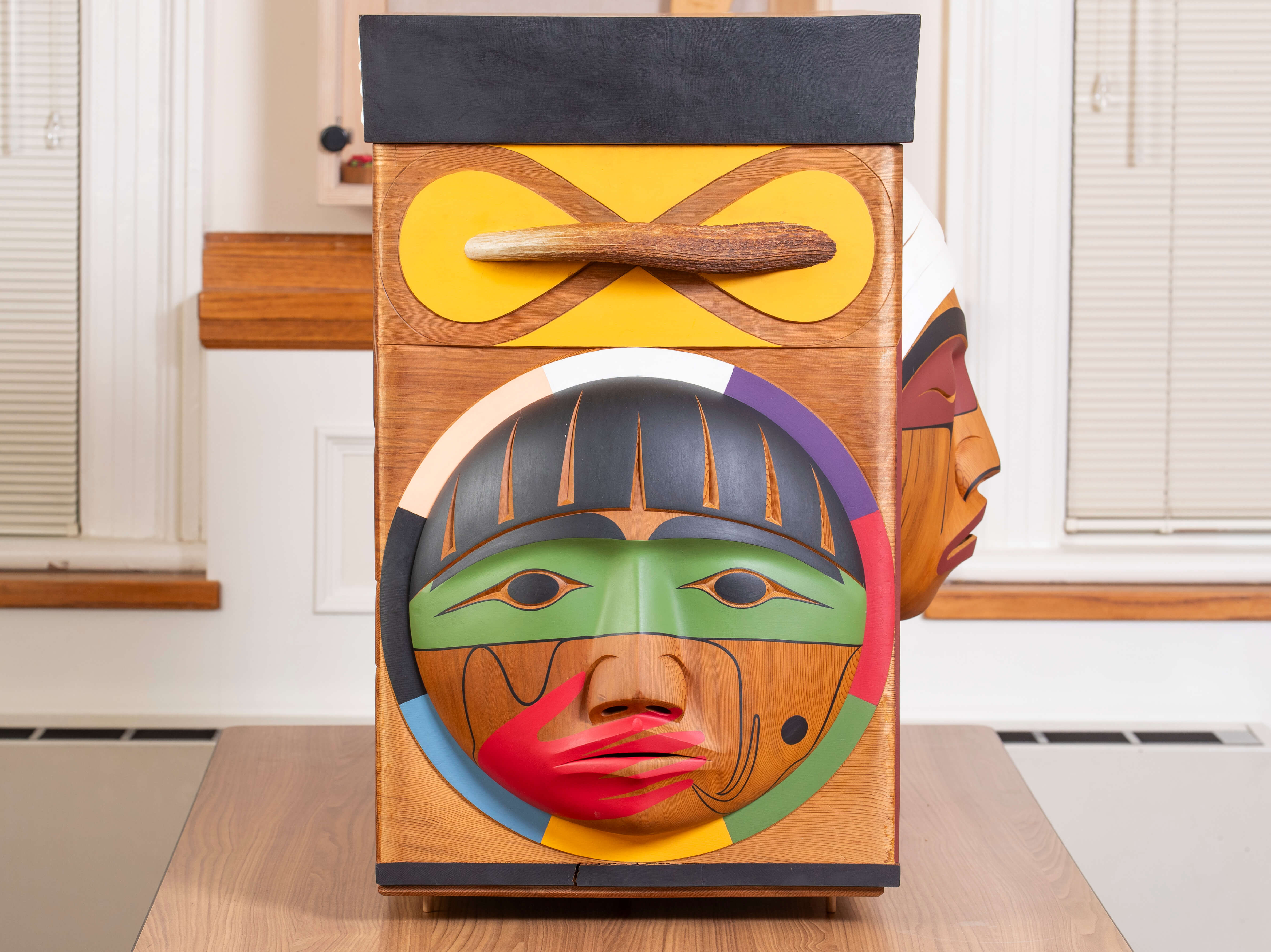 The side of the Bentwood Box, displaying imagery representing former Métis residential school students.